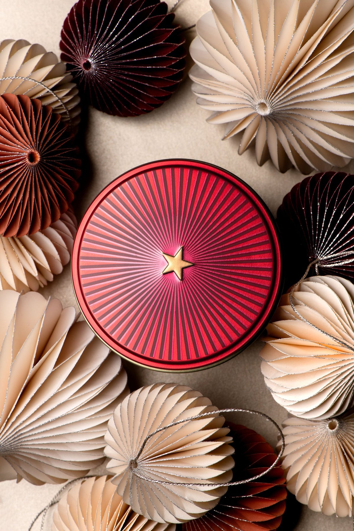 Dammann Frères Christmas Tea red star metal tin among paper baubles